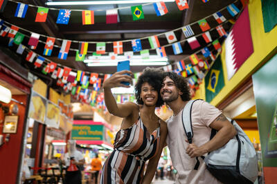 Two people taking a selfie at the Municipal Market of São Paulo, Brazil