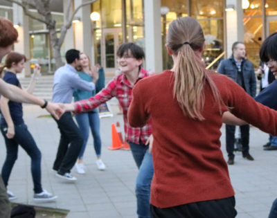 Group of students swing dancing in front of the student book store